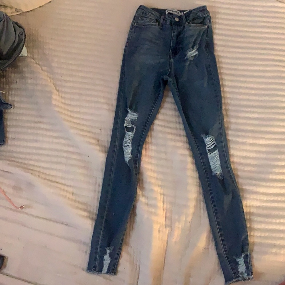 Cute skinny blue jeans with rips and ruffled bottom